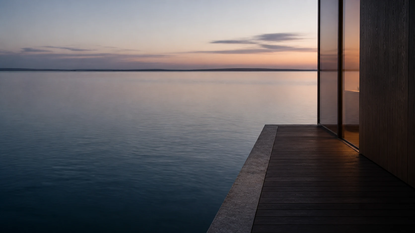 Still water at blue hour meets the quiet edge of a private lakeside terrace.