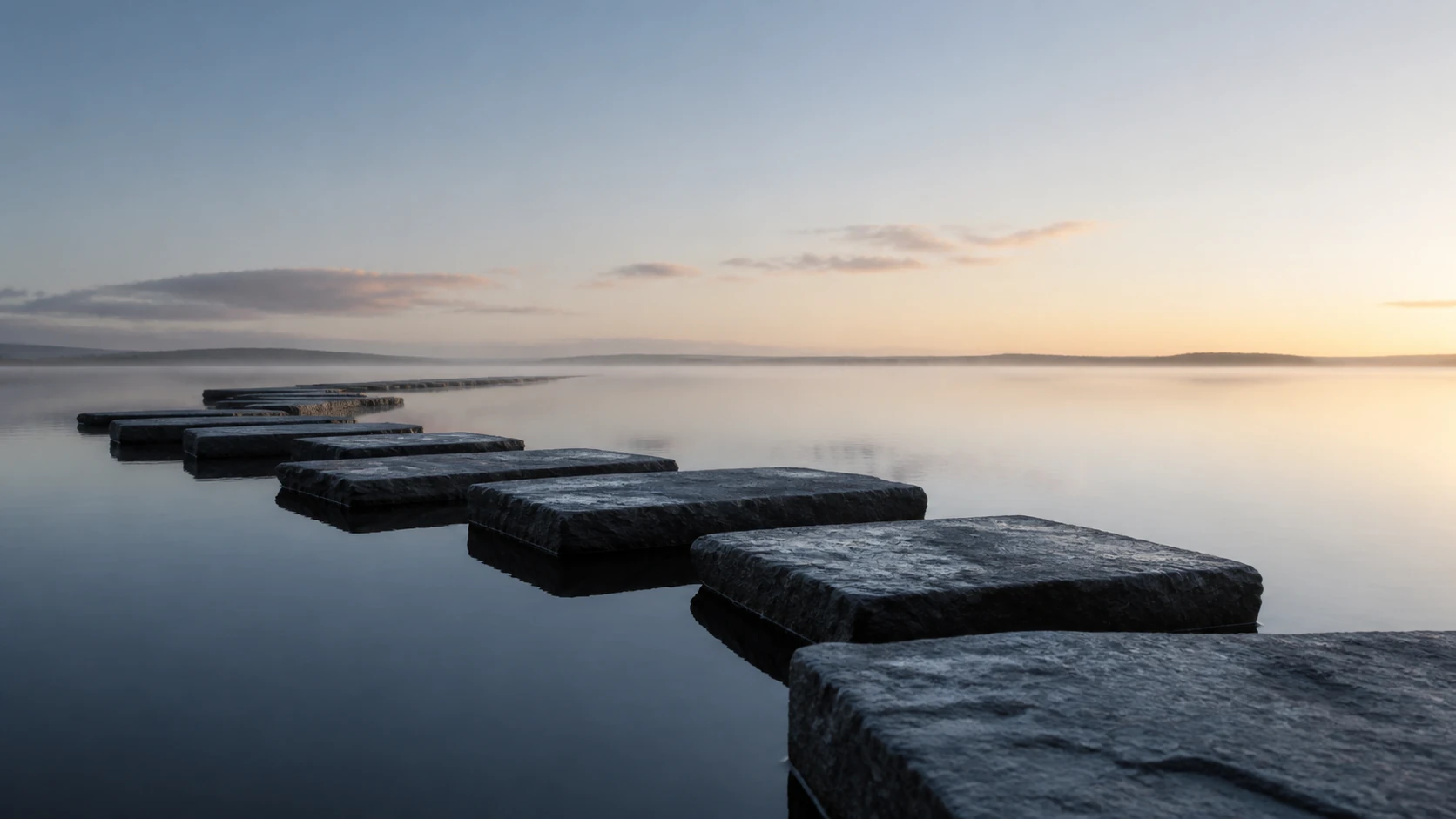 Broad basalt planes cross still water in a measured sequence toward the horizon.