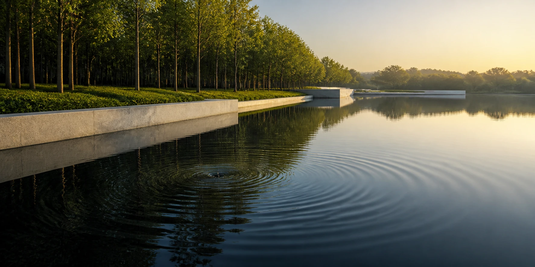 A single ripple widens across a calm reflecting pool at first light.