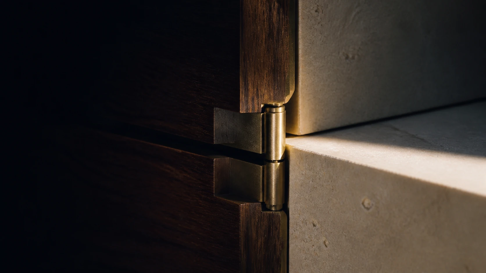 A precise stone and timber joint carries two structures across one continuous seam.